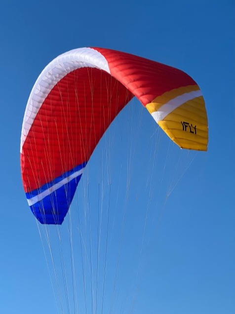 iFLY Gliders paraglider in red, blue, yellow and white