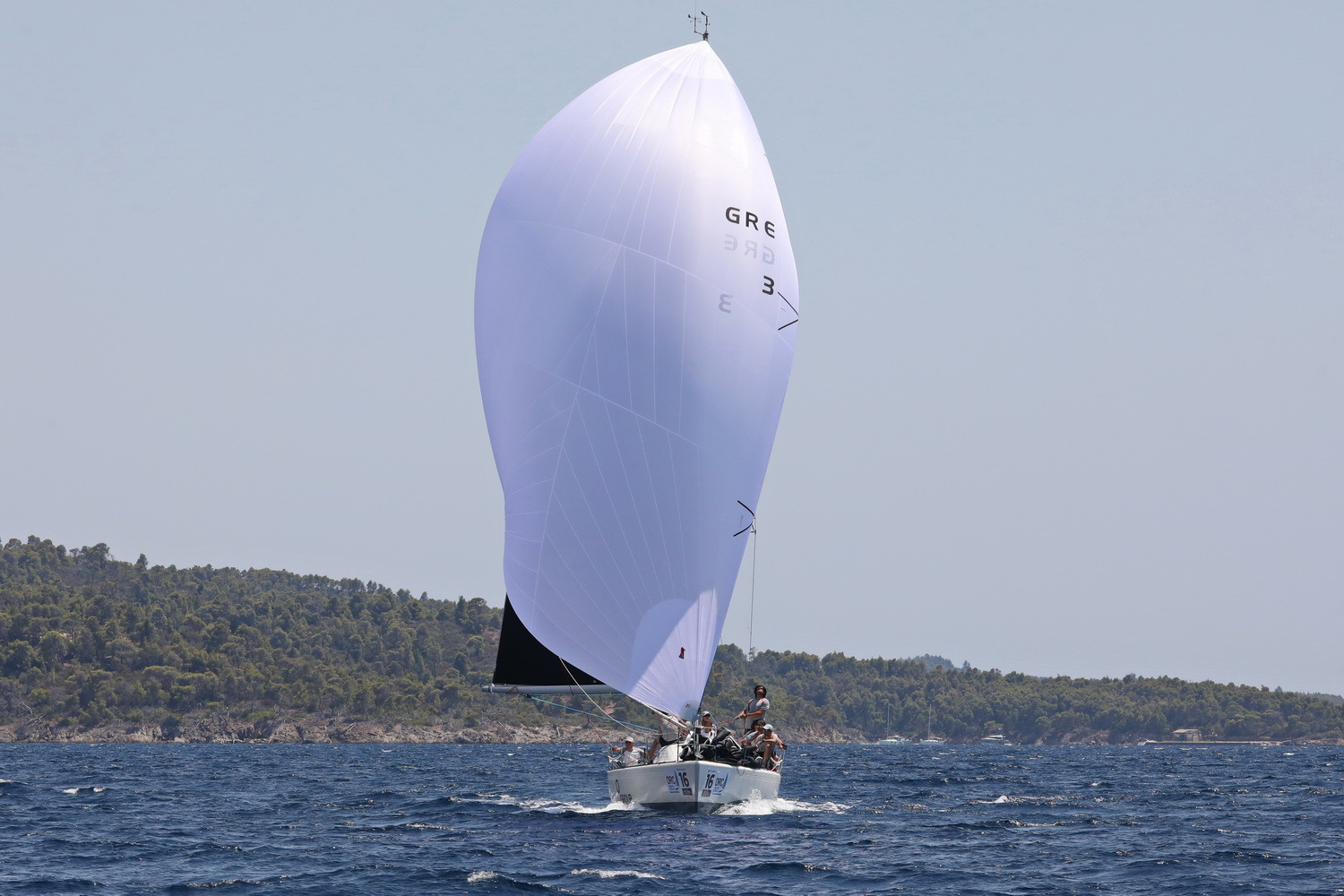 sailing boat white spinnaker sail front view